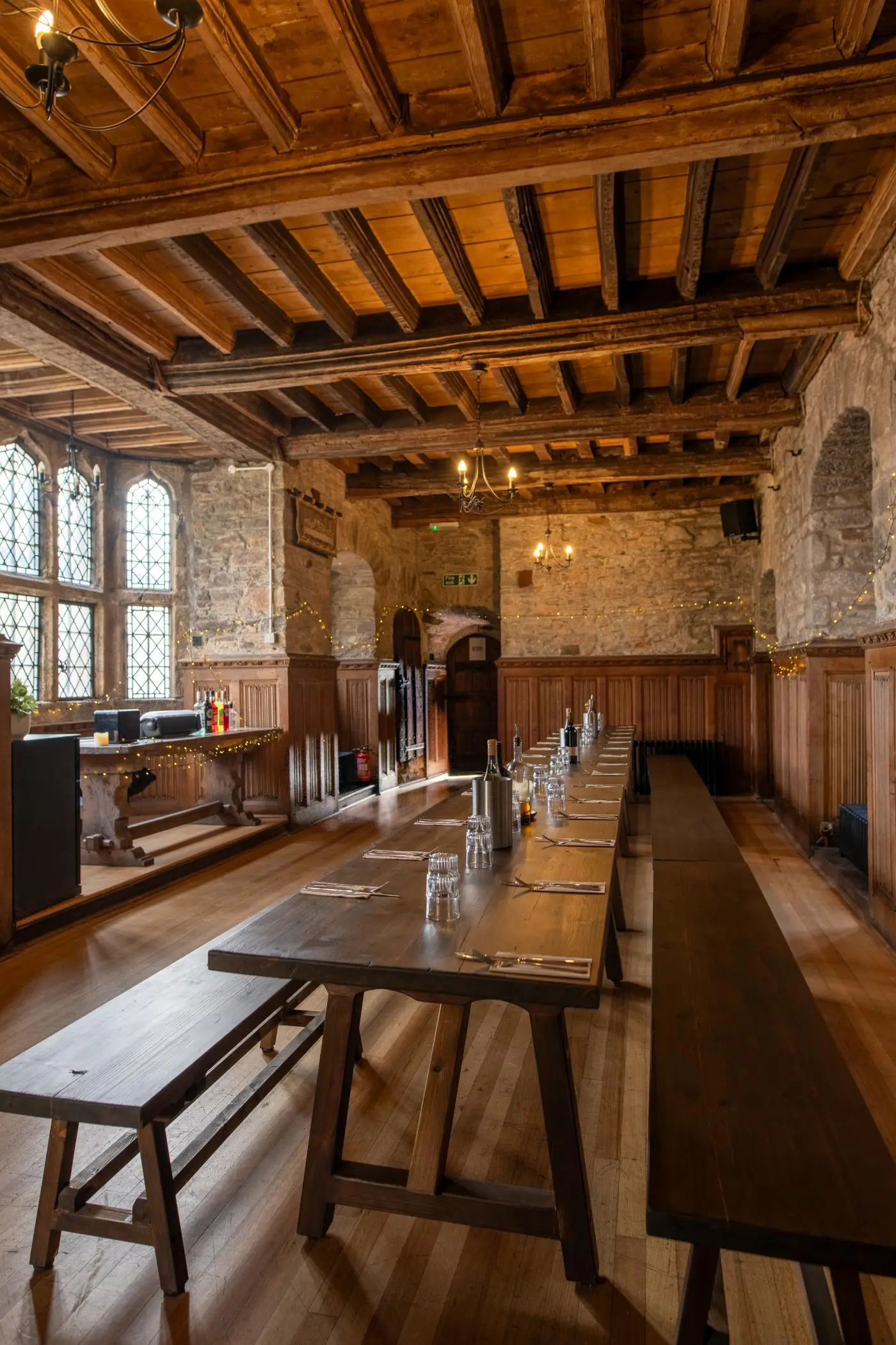 The Main Hall: stone walls, beams and long wooden tables